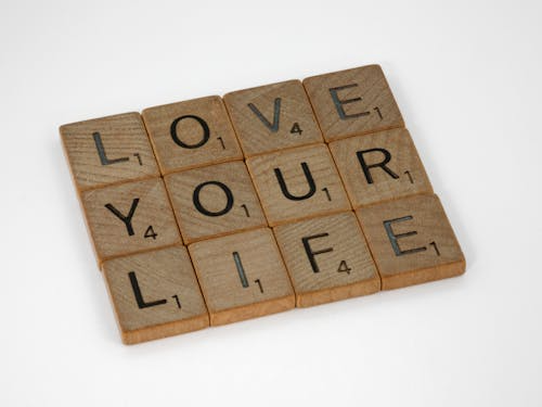 Scrabble tiles arranged to say 'LOVE YOUR LIFE'.